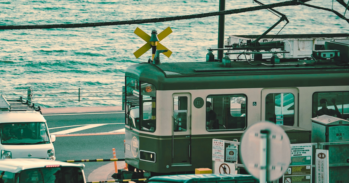 A quiet seaside train passing through Kamakura, Japan, capturing a calm moment between everyday life and travel